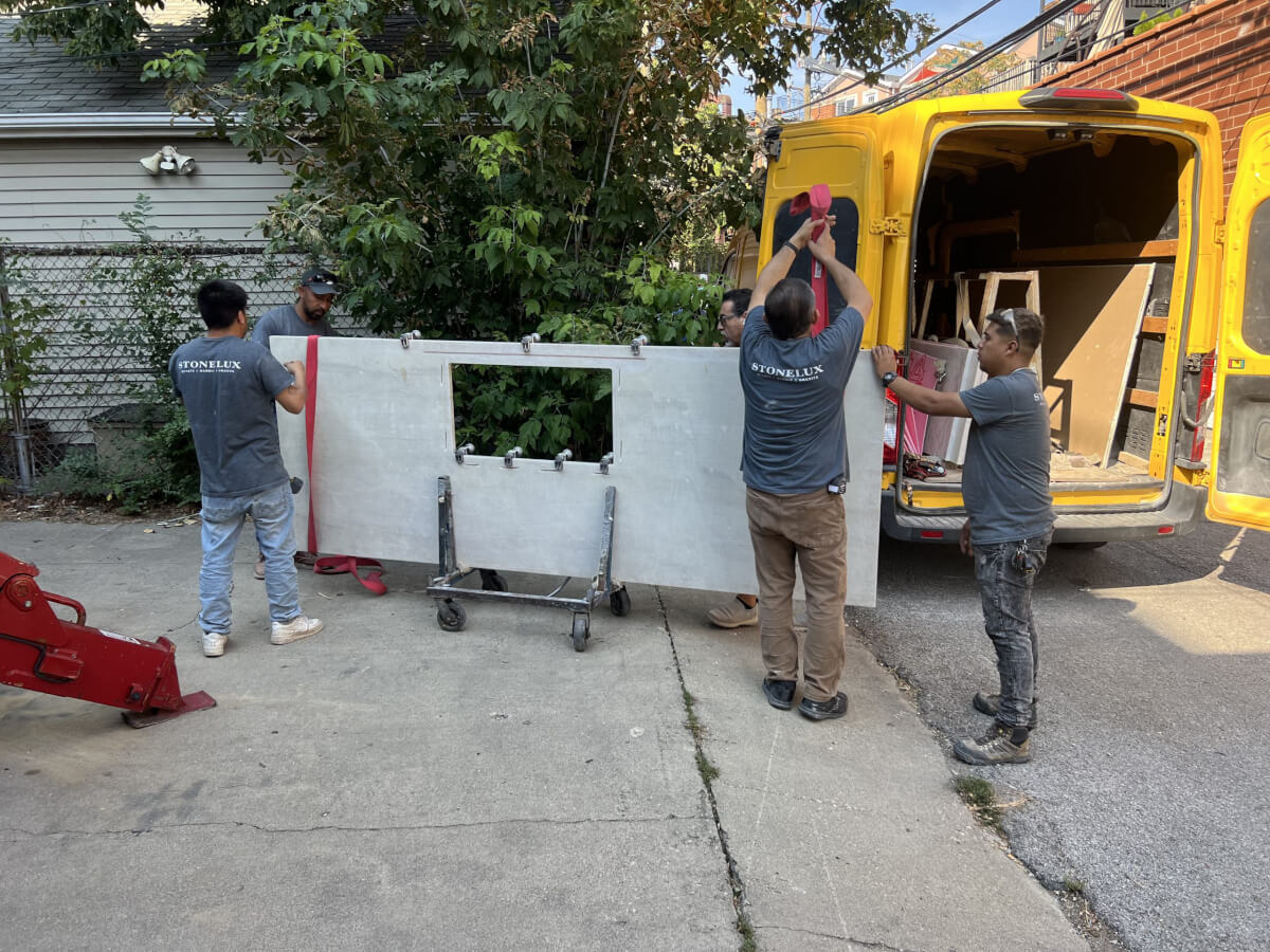 STONELUX installation crew carefully moving a custom countertop